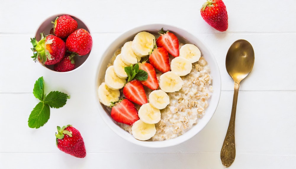 a bowl of oatmeal with strawberries and bananas