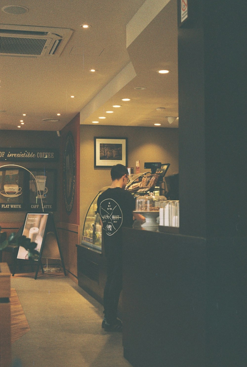 a man standing at a counter in a restaurant