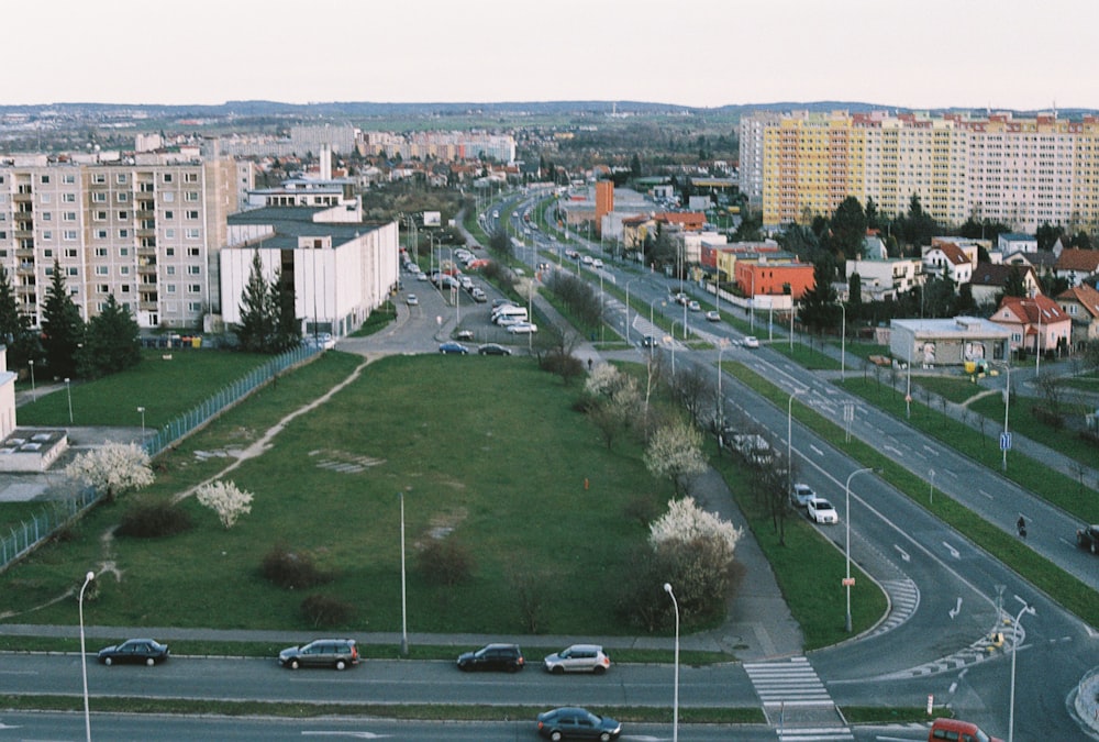 a large grassy field in the middle of a city