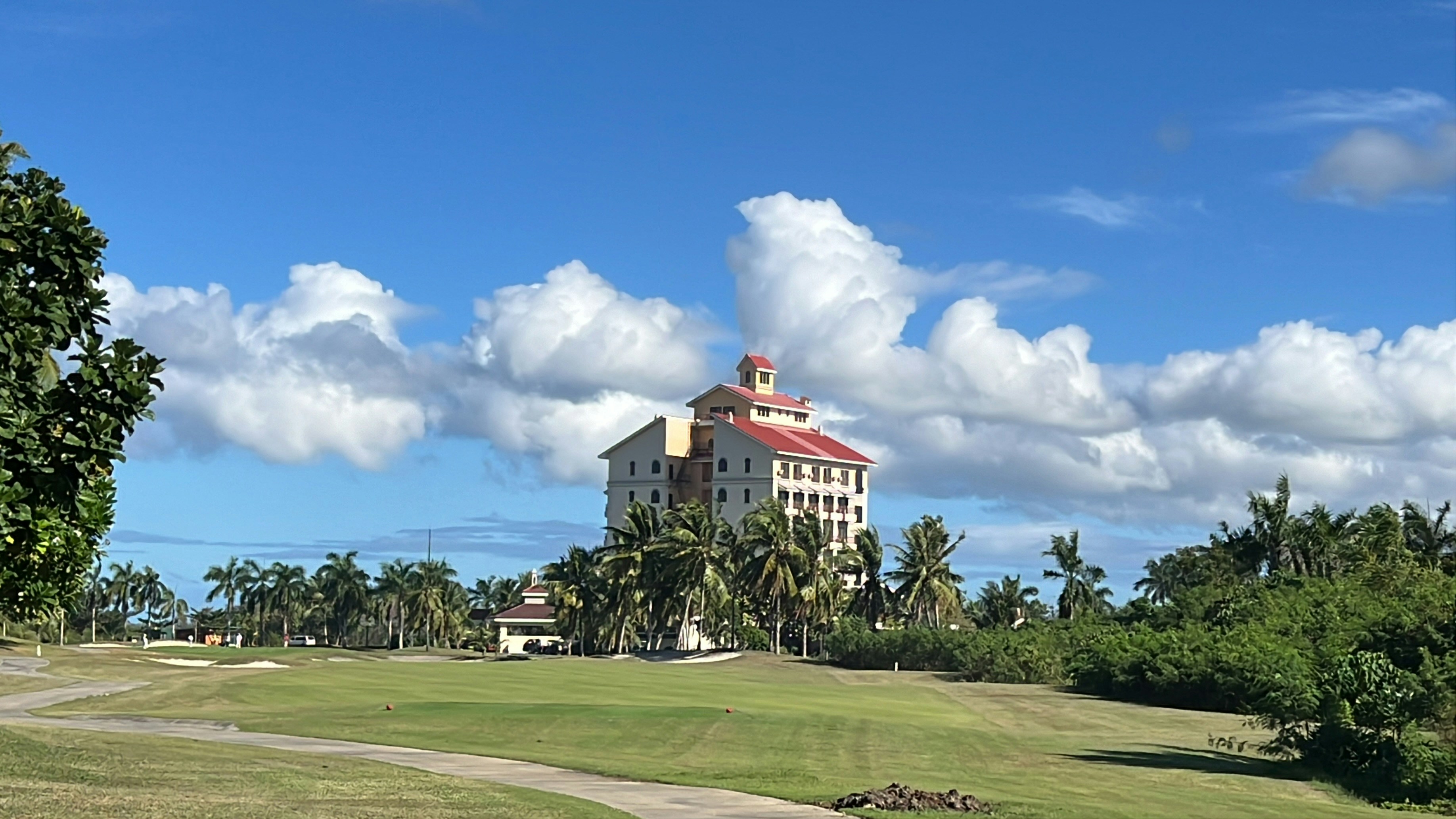 a golf course with a building in the background