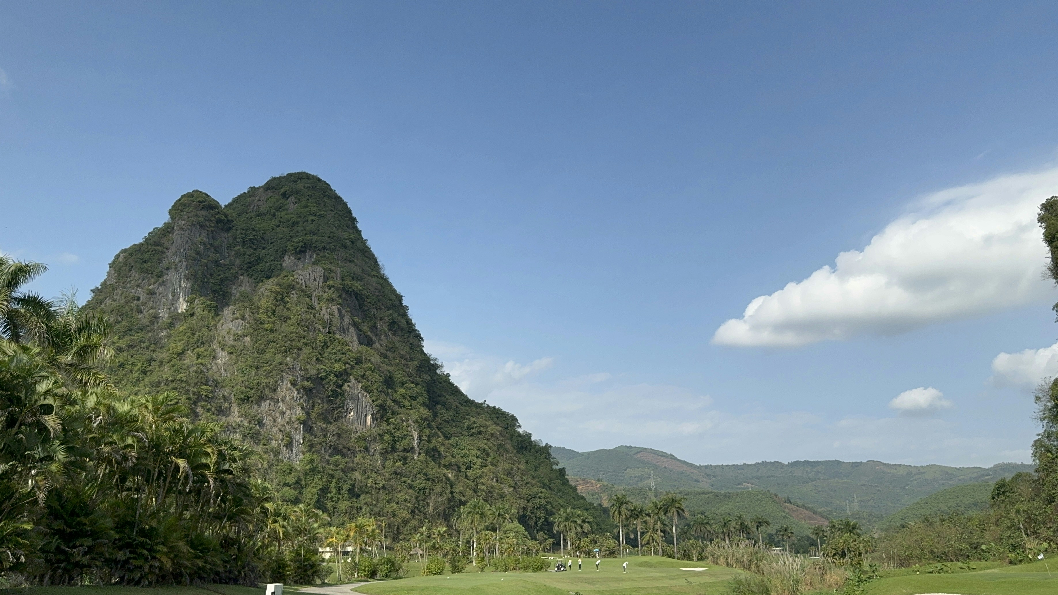 a golf course with a mountain in the background