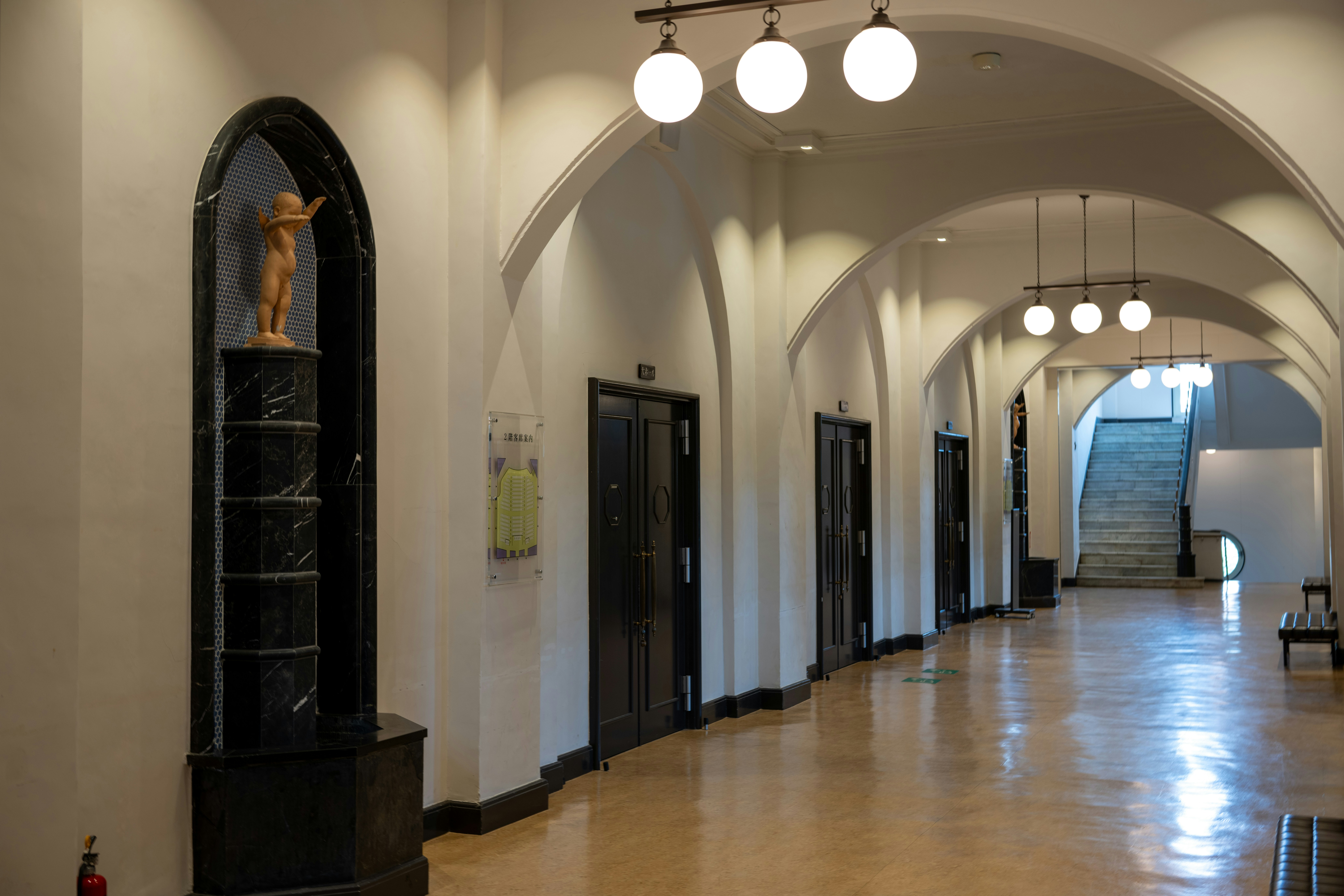 a long hallway with a clock on the wall