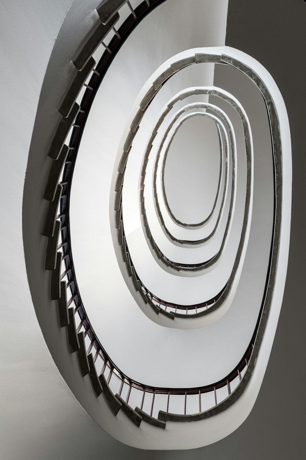 a spiral staircase in a building with white walls