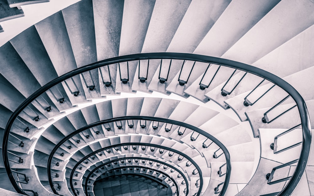 a black and white photo of a spiral staircase