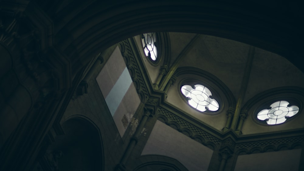 a view of the ceiling of a church with three windows