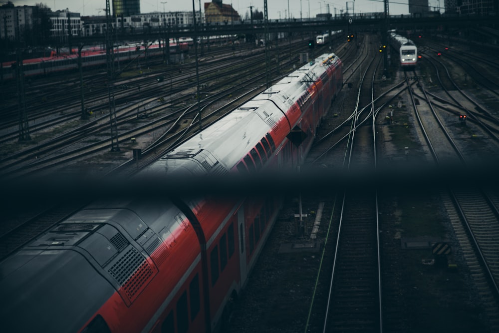 a red and white train traveling down train tracks