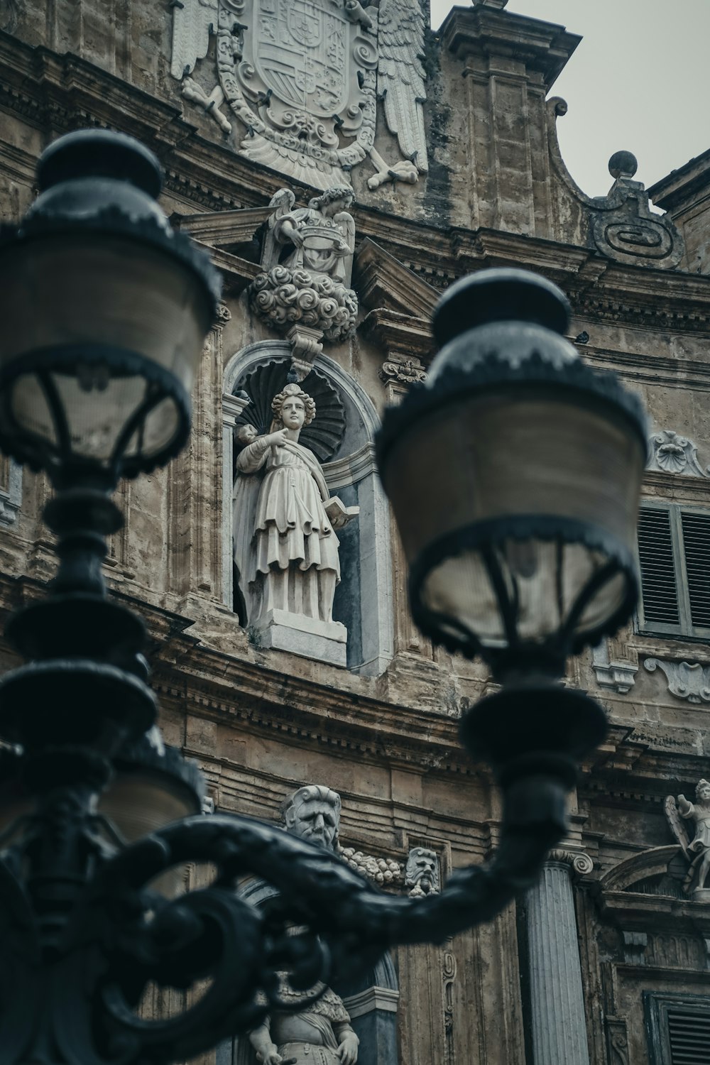a street light with a statue on the side of it