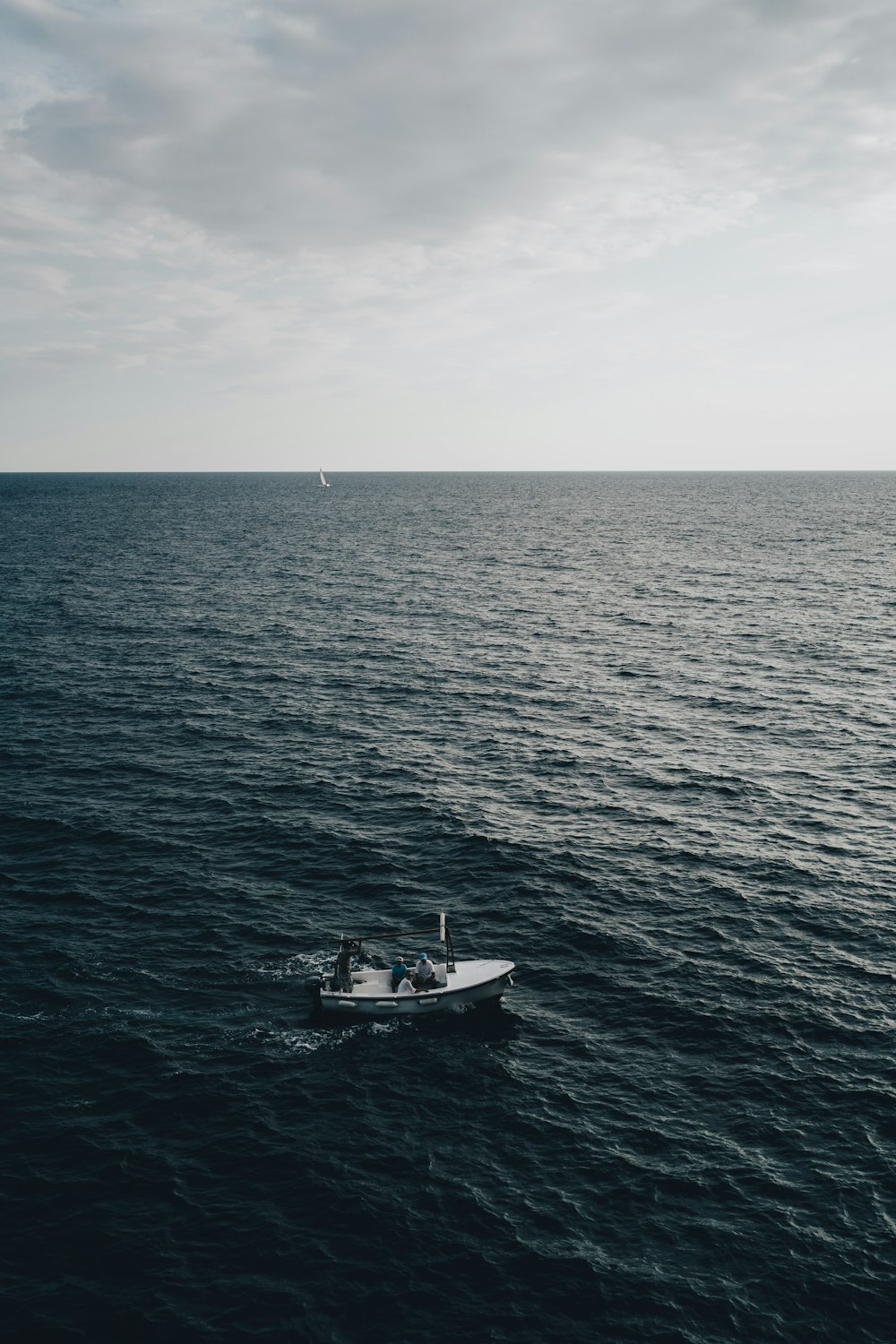 a small boat floating on top of a large body of water