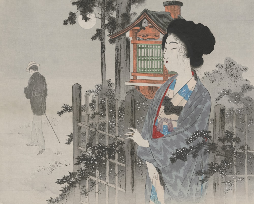 a woman in a kimono standing next to a fence