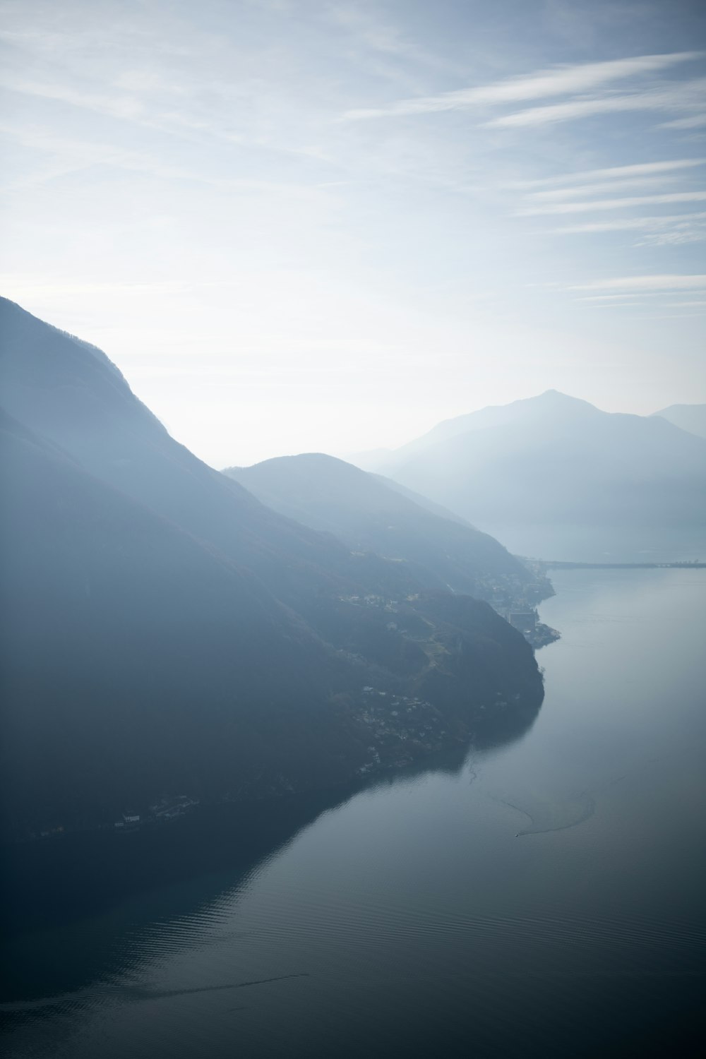 a body of water with mountains in the background