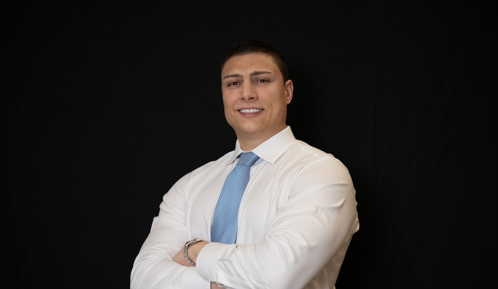 a man in a white shirt and blue tie