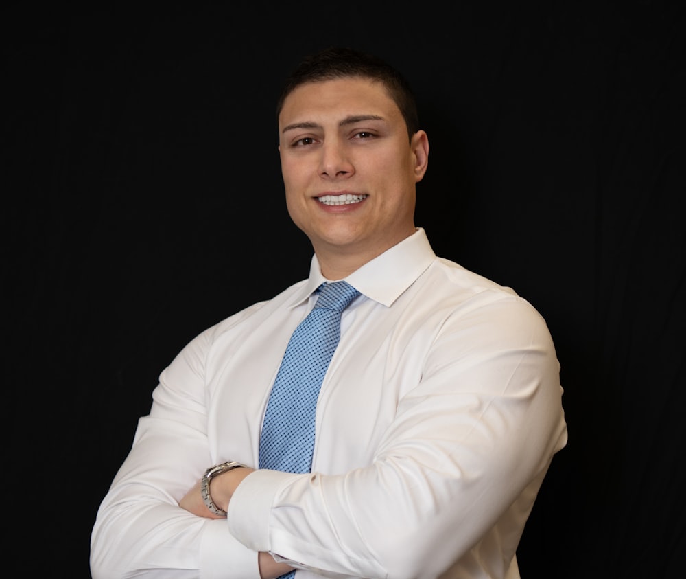 a man in a white shirt and blue tie