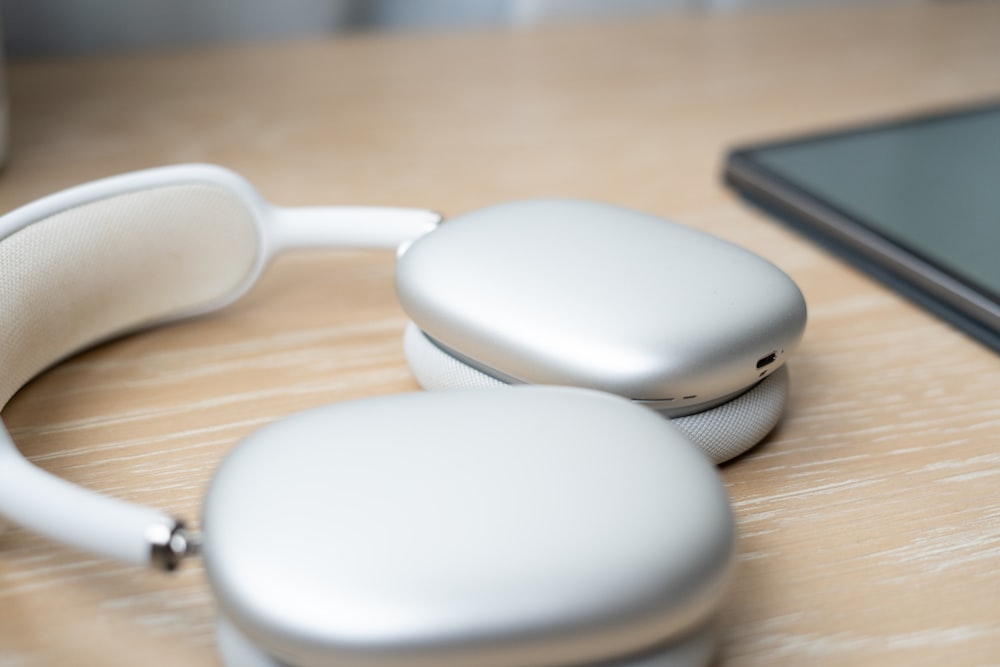 a pair of headphones sitting on top of a wooden table