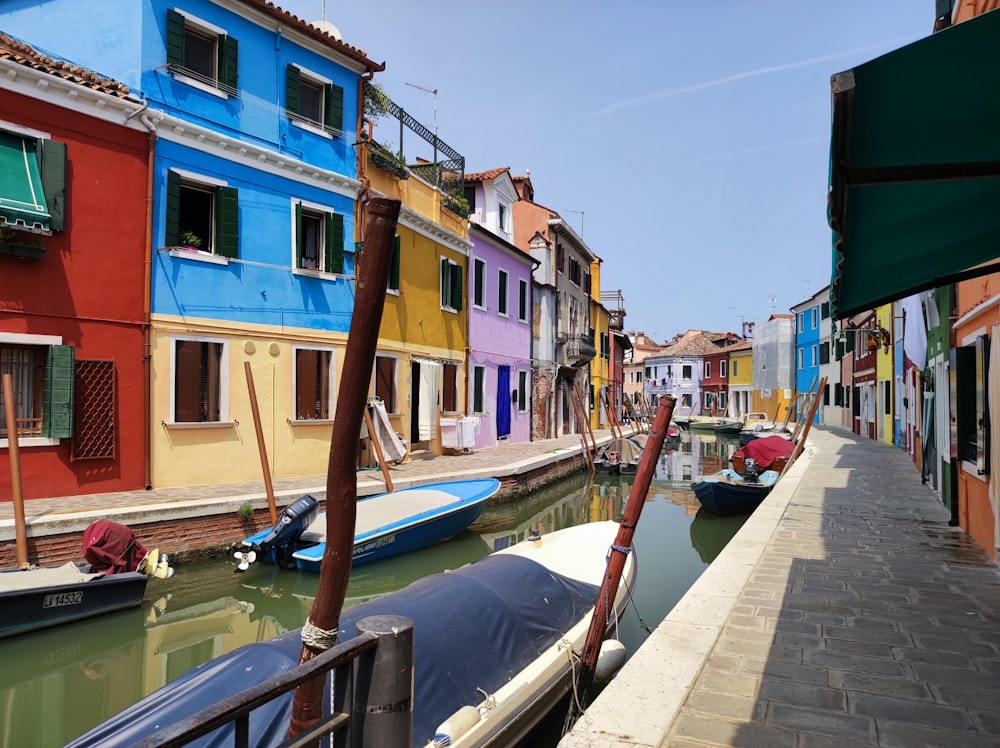 a row of colorful buildings next to a body of water