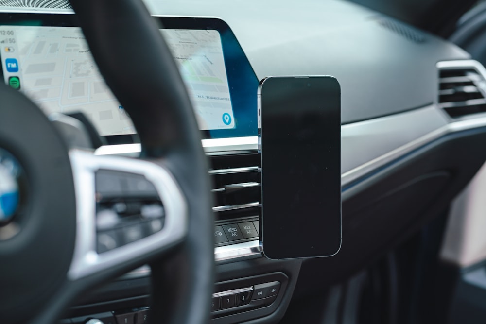 a close up of a car dashboard with a cell phone