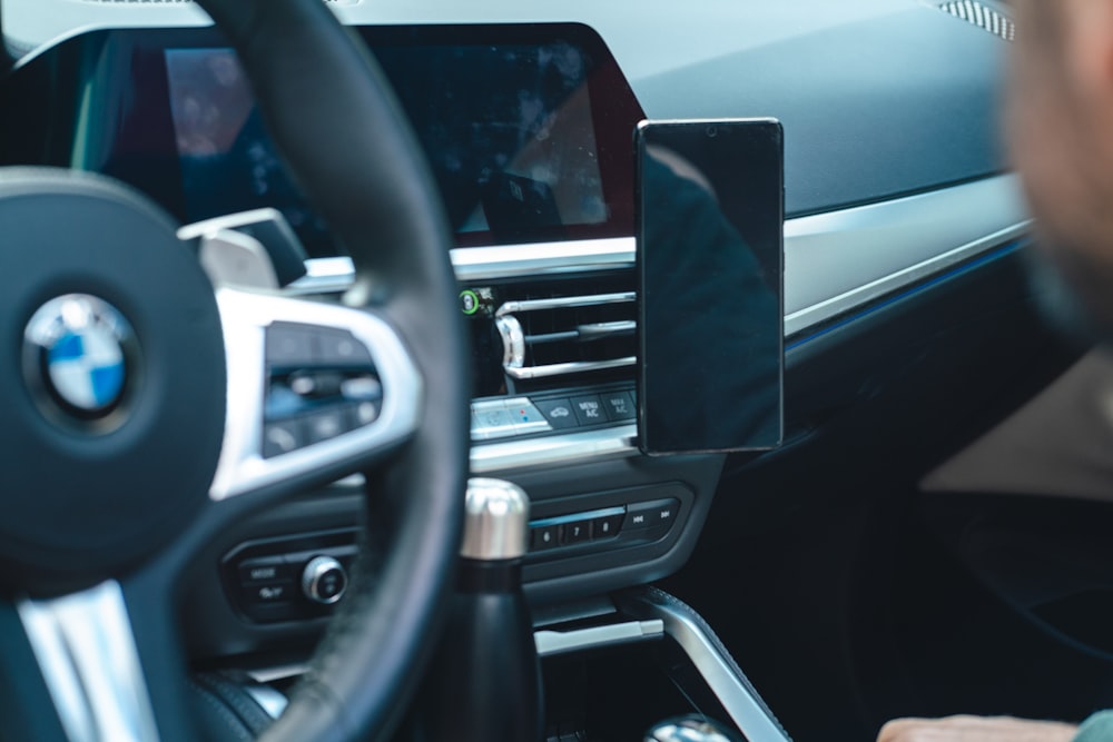 a man sitting in a car with a steering wheel