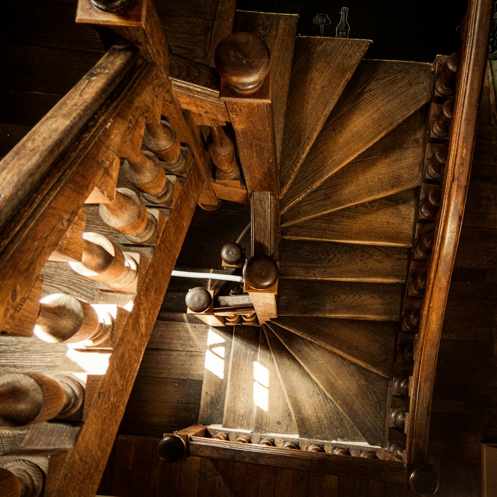 a wooden stair case with a bunch of hats on top of it