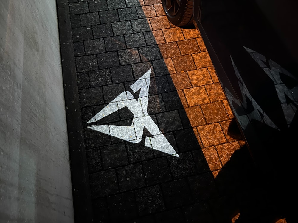 a black and white floor with a white arrow painted on it