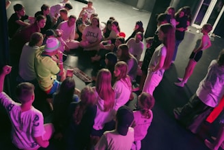a group of people standing around a table