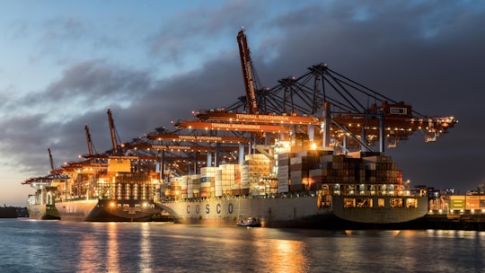 a large cargo ship in a harbor at night