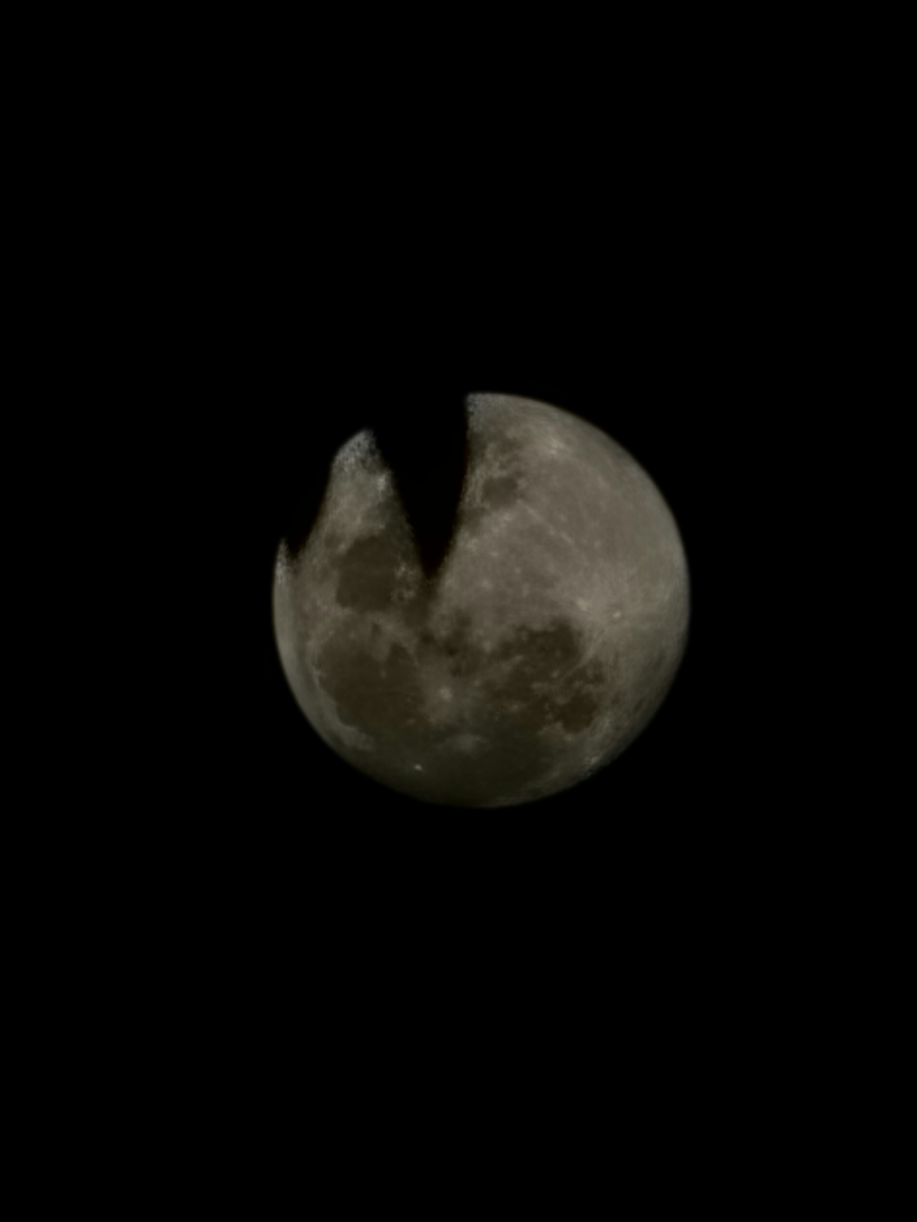 a full moon seen through a telescope lens