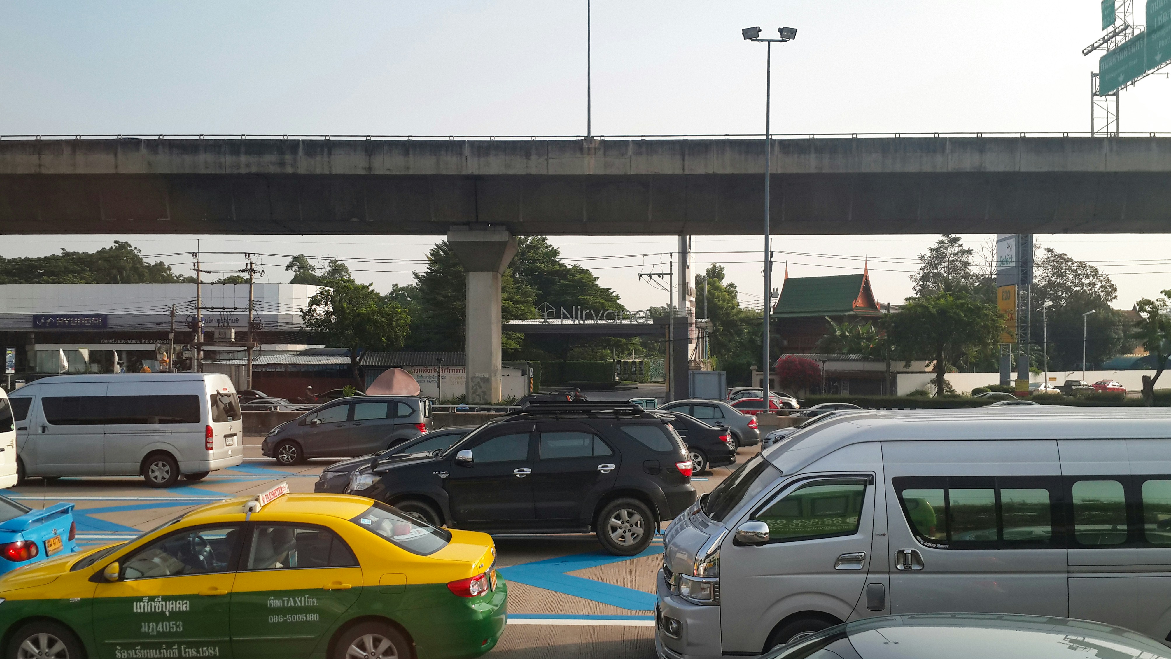 Several electric cars parked and charging at a modern public charging station