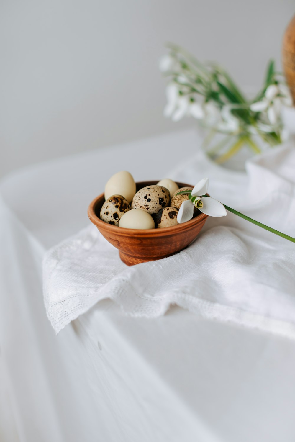 a bowl filled with eggs sitting on top of a table