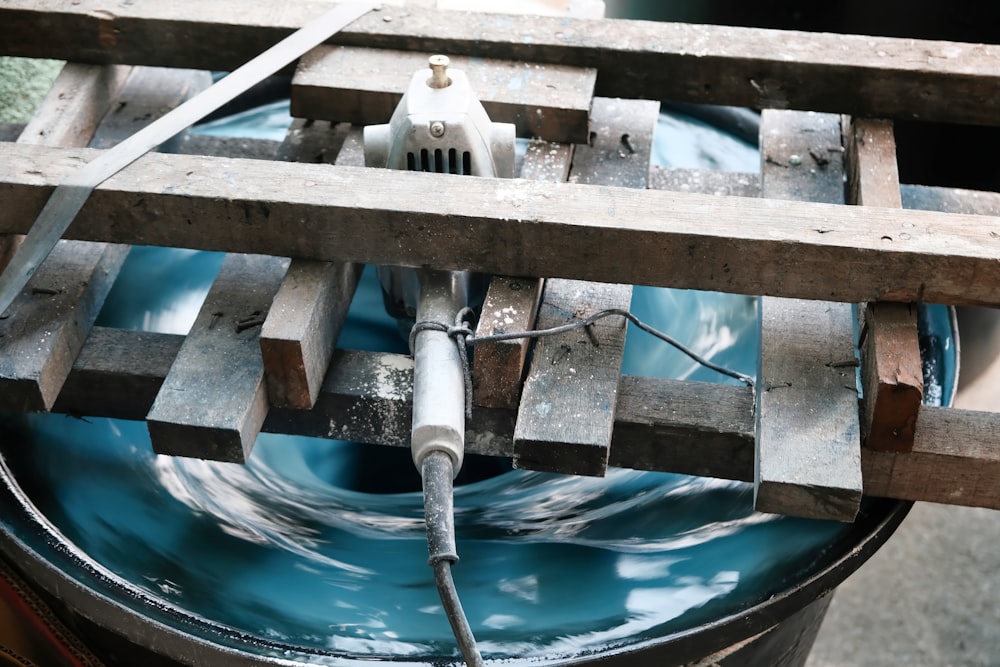 a bucket filled with water and a hose connected to it