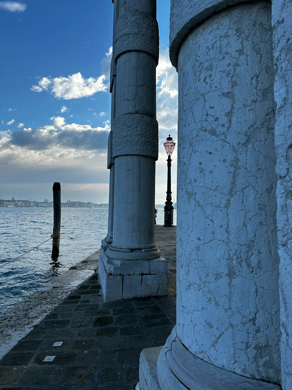 a couple of pillars sitting next to a body of water