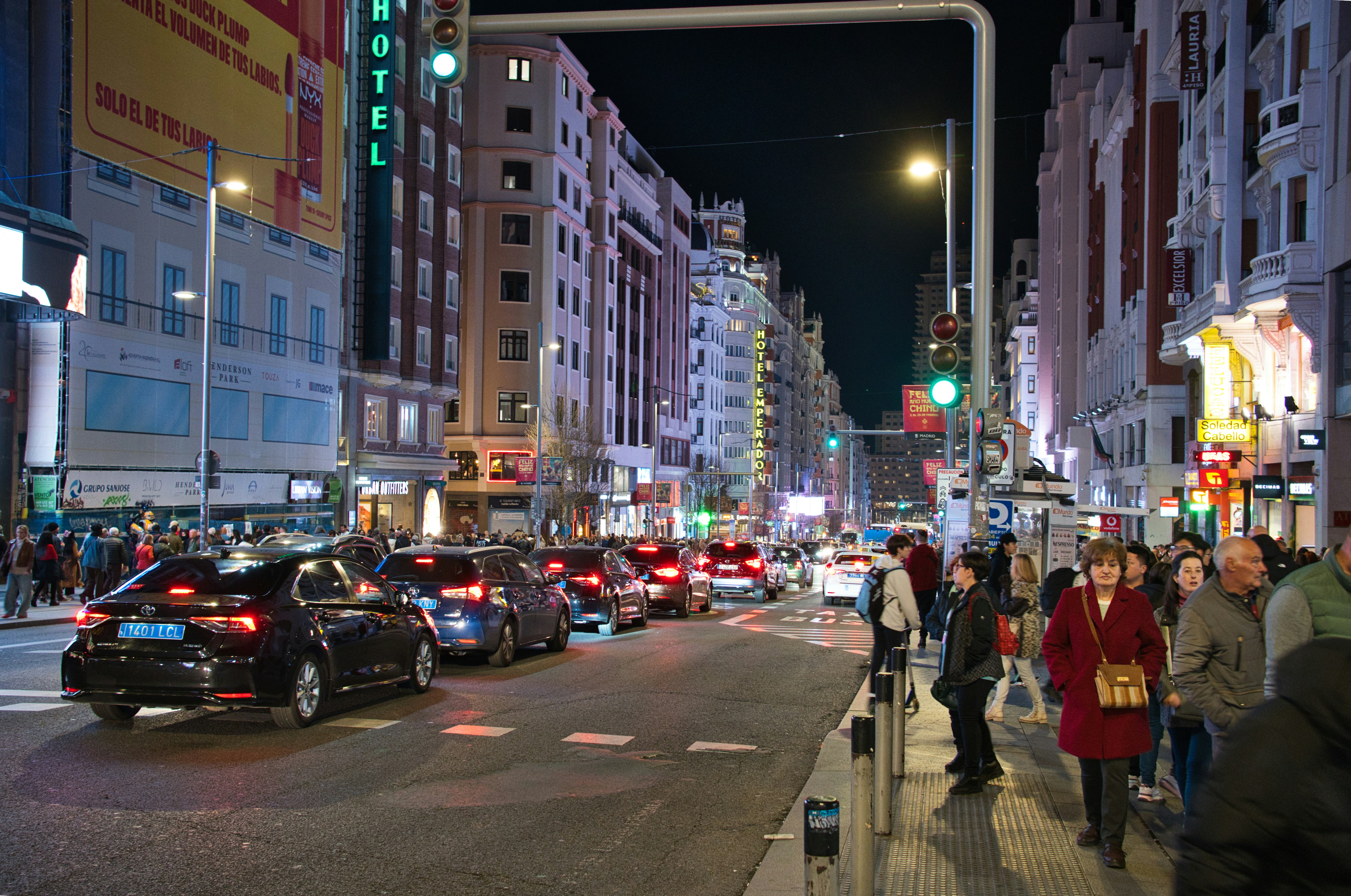 Used compact sedan driving through a city street, representing affordable cars under $20K