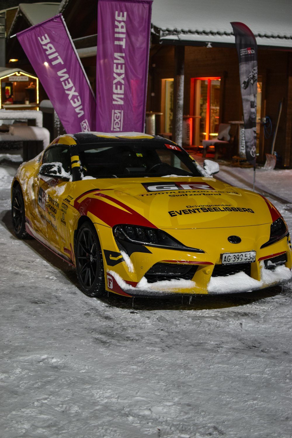 a yellow sports car parked in the snow