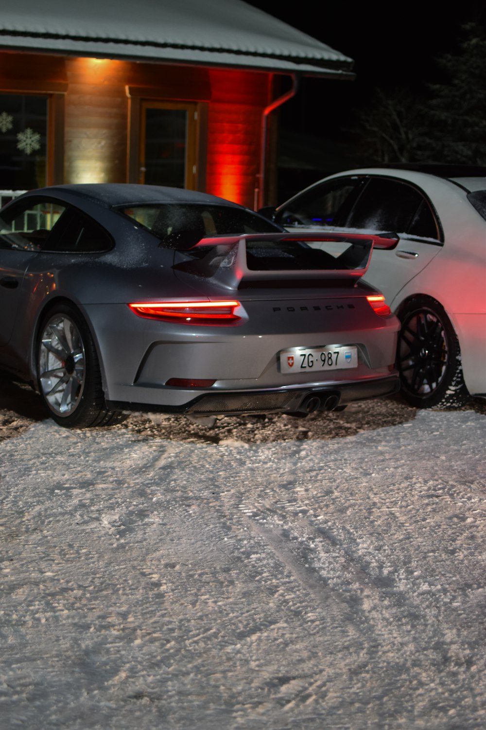 a couple of cars parked next to each other in the snow