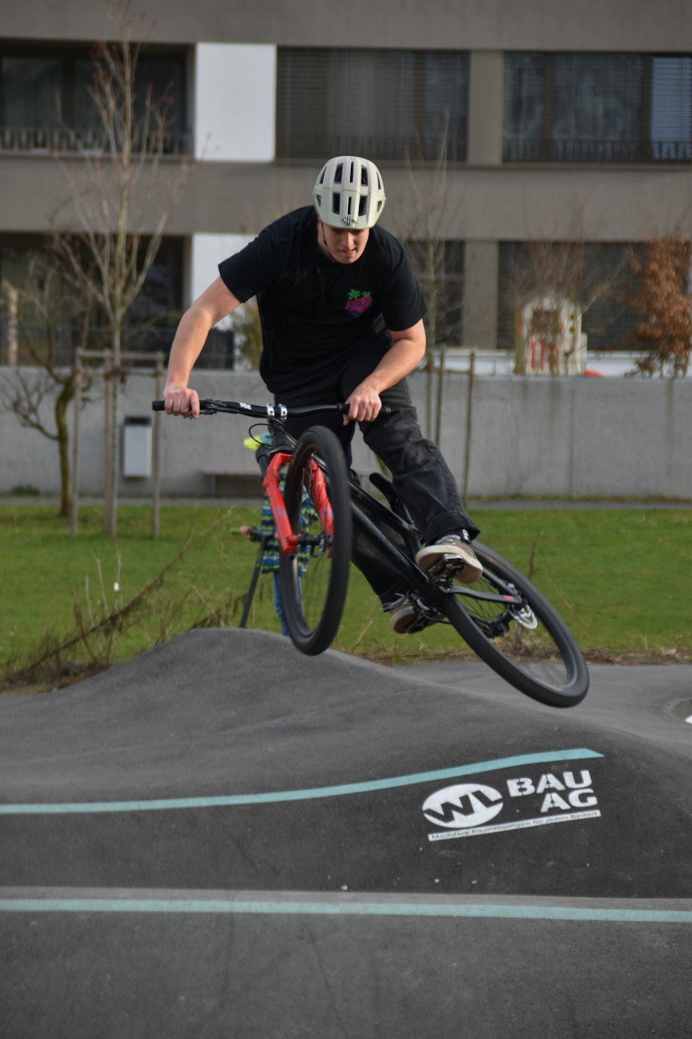 a man riding a bike up the side of a ramp