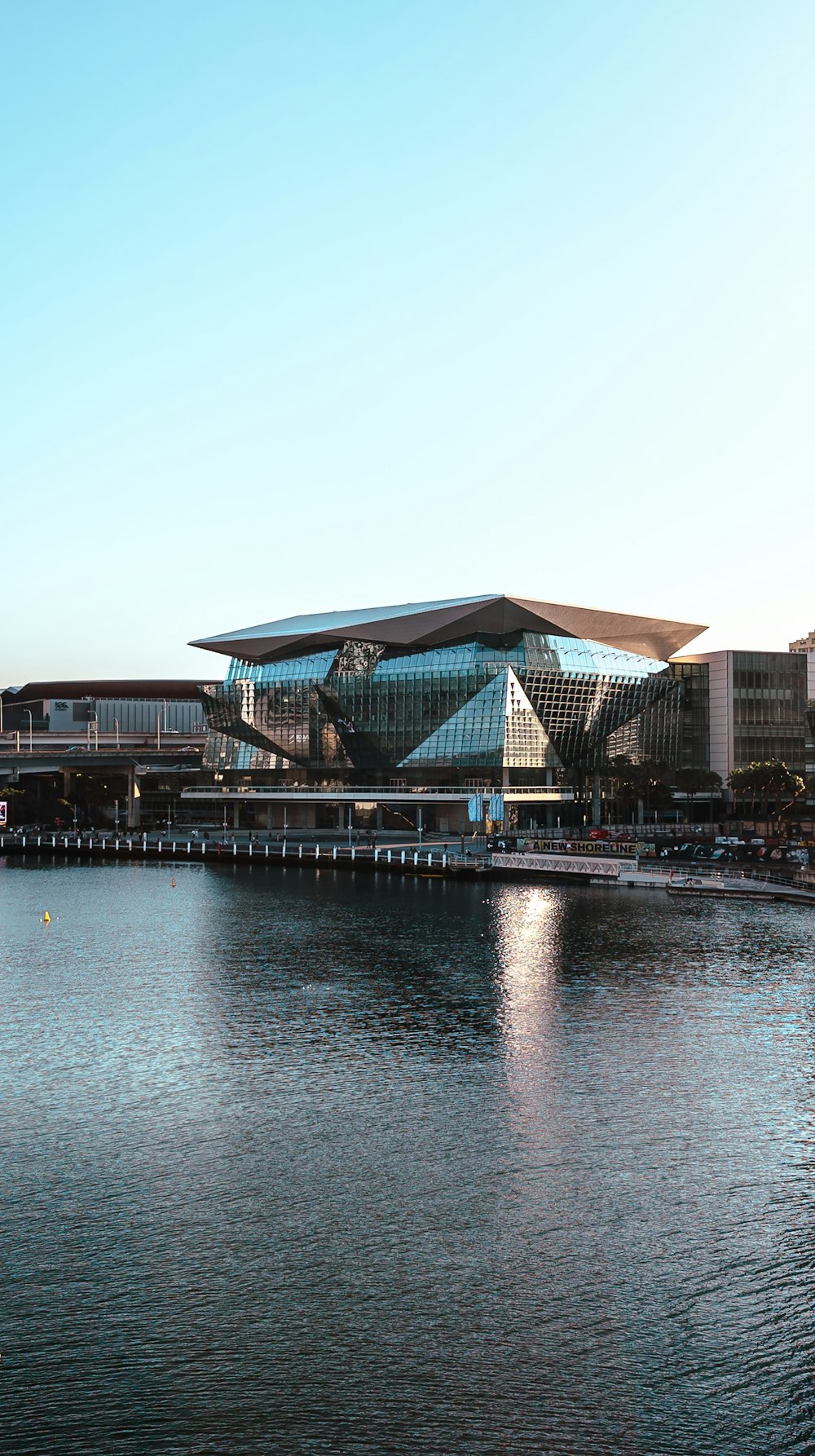 a large body of water with a building in the background