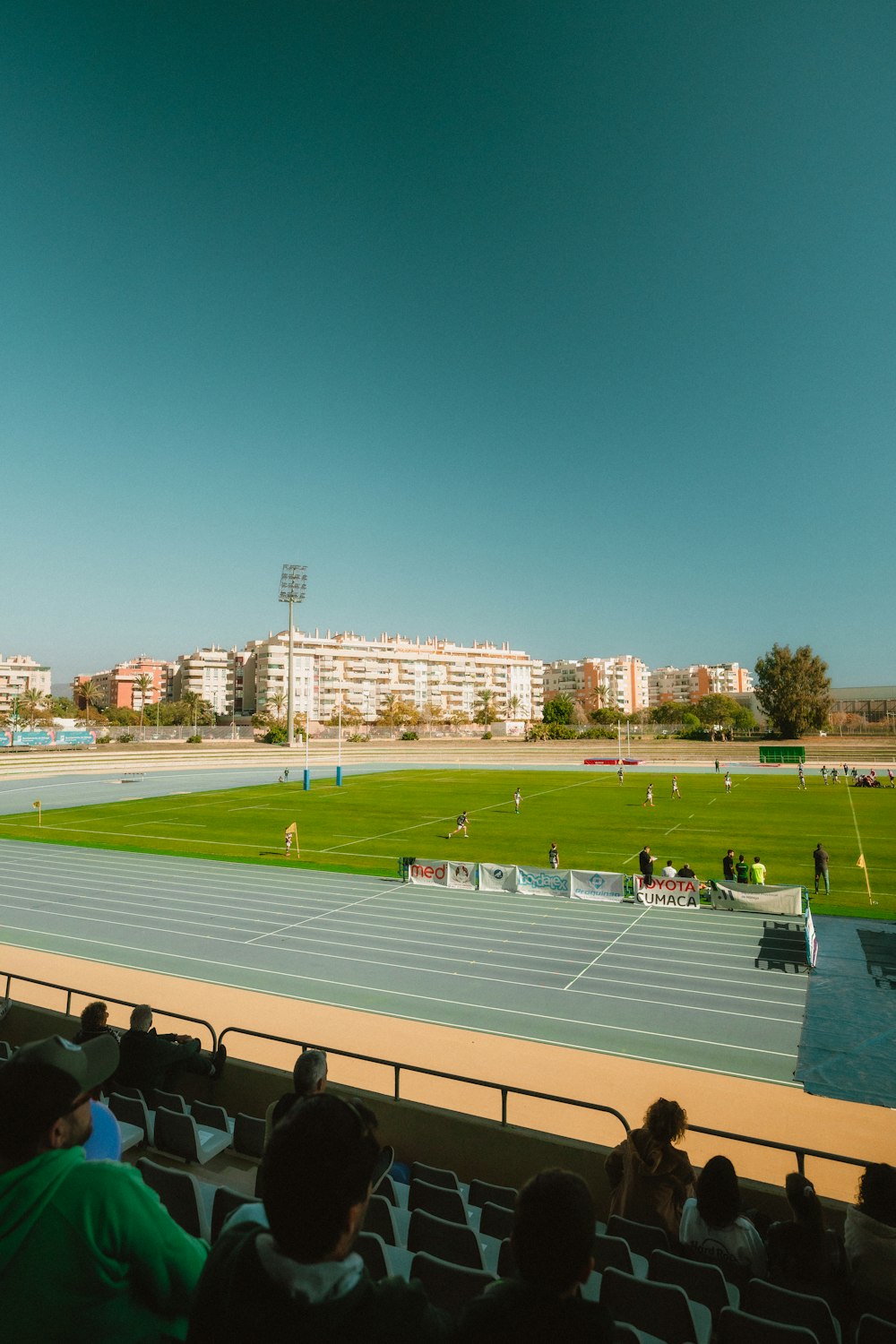 a group of people sitting in a stadium watching a game