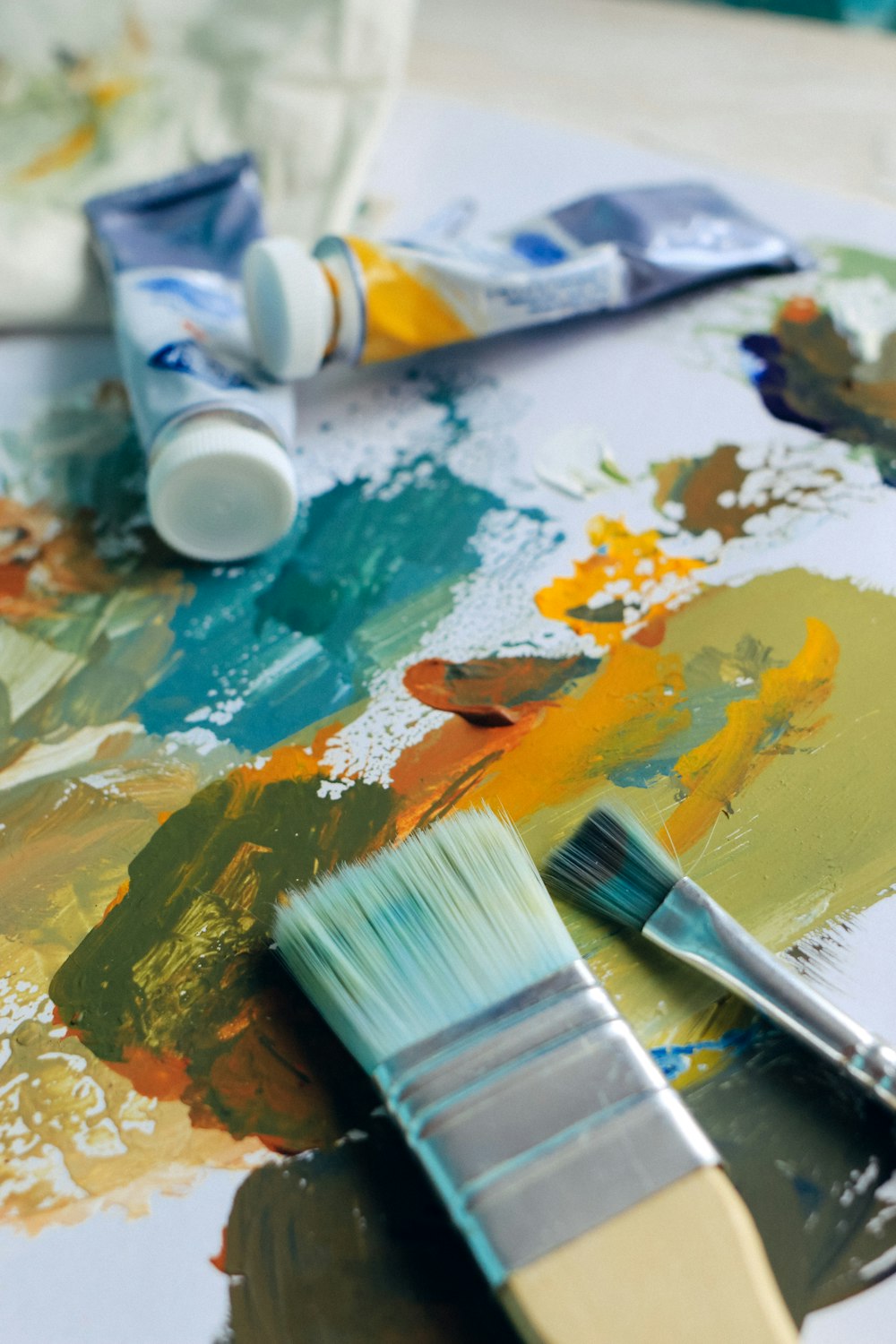 a close up of a paintbrush and some paint on a table