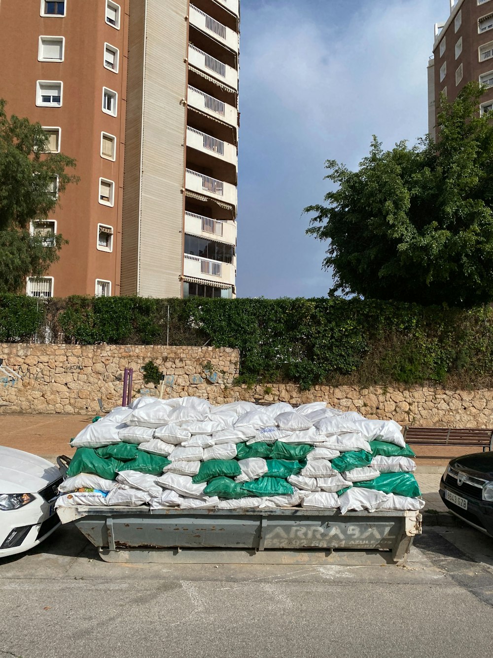 a pile of sand sitting next to a parking lot