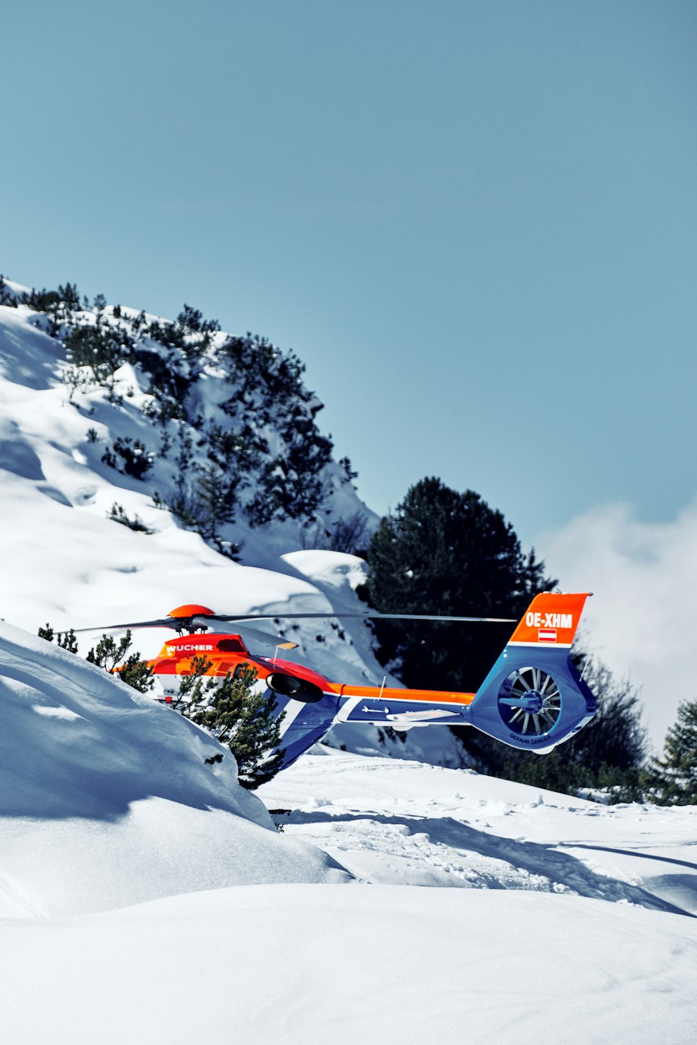 a helicopter that is flying over some snow