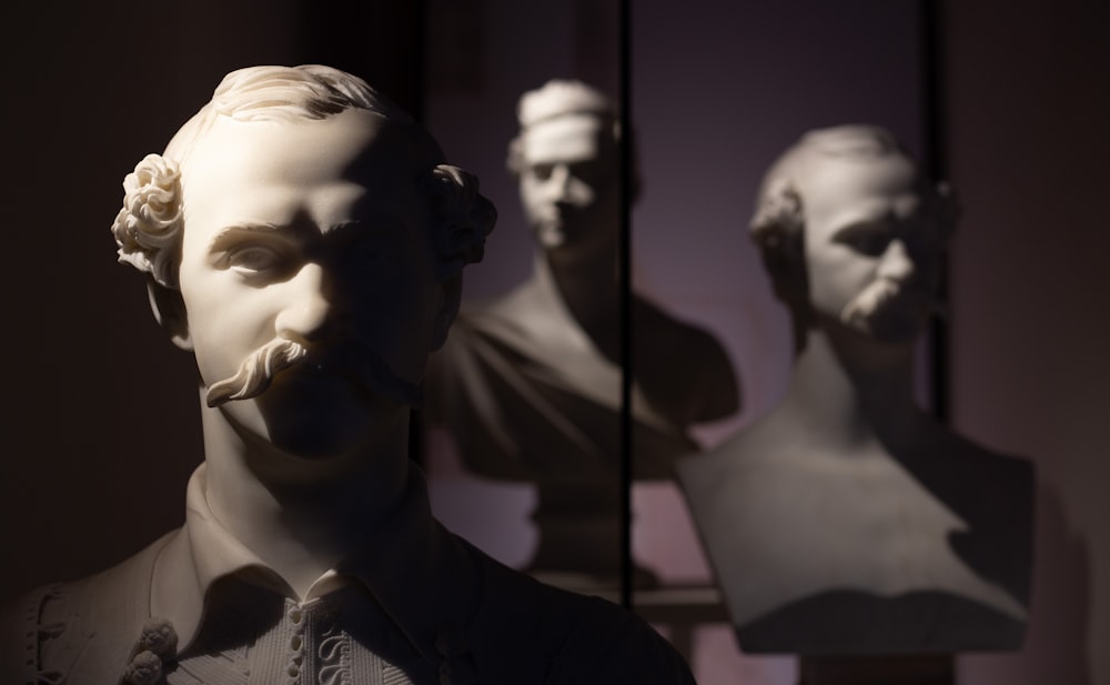 a statue of a man with a beard in front of a mirror