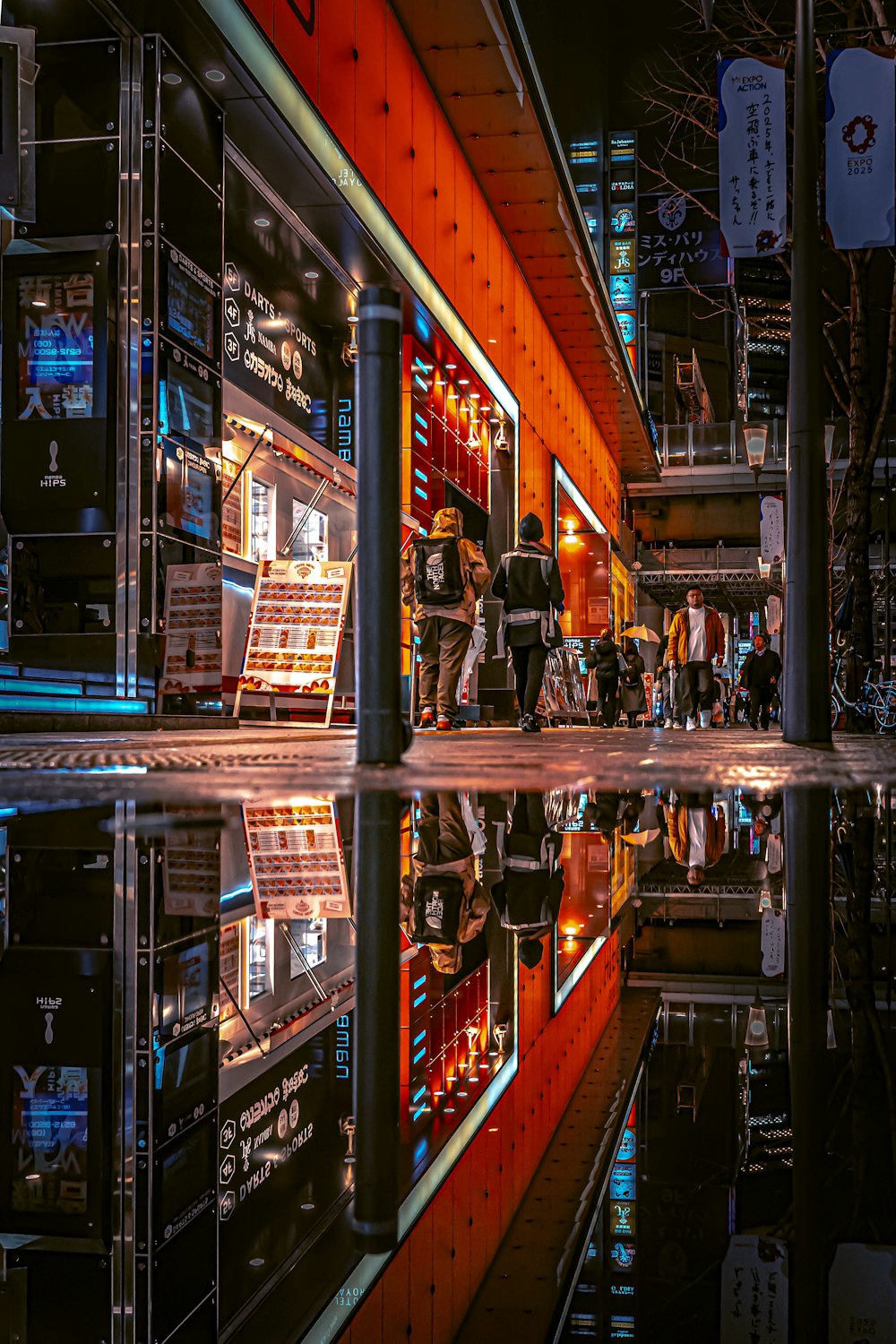 a group of people walking down a street next to a building