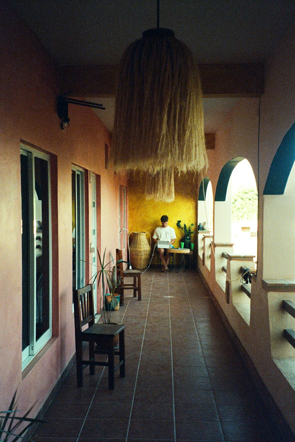 a person sitting at a table on a balcony