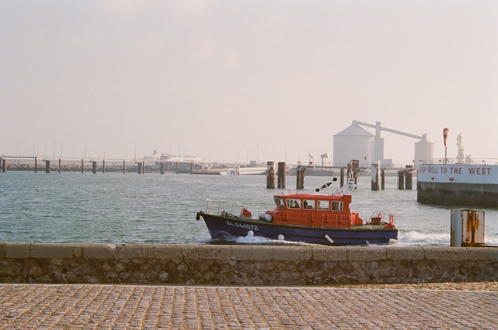 a red and blue boat is in the water