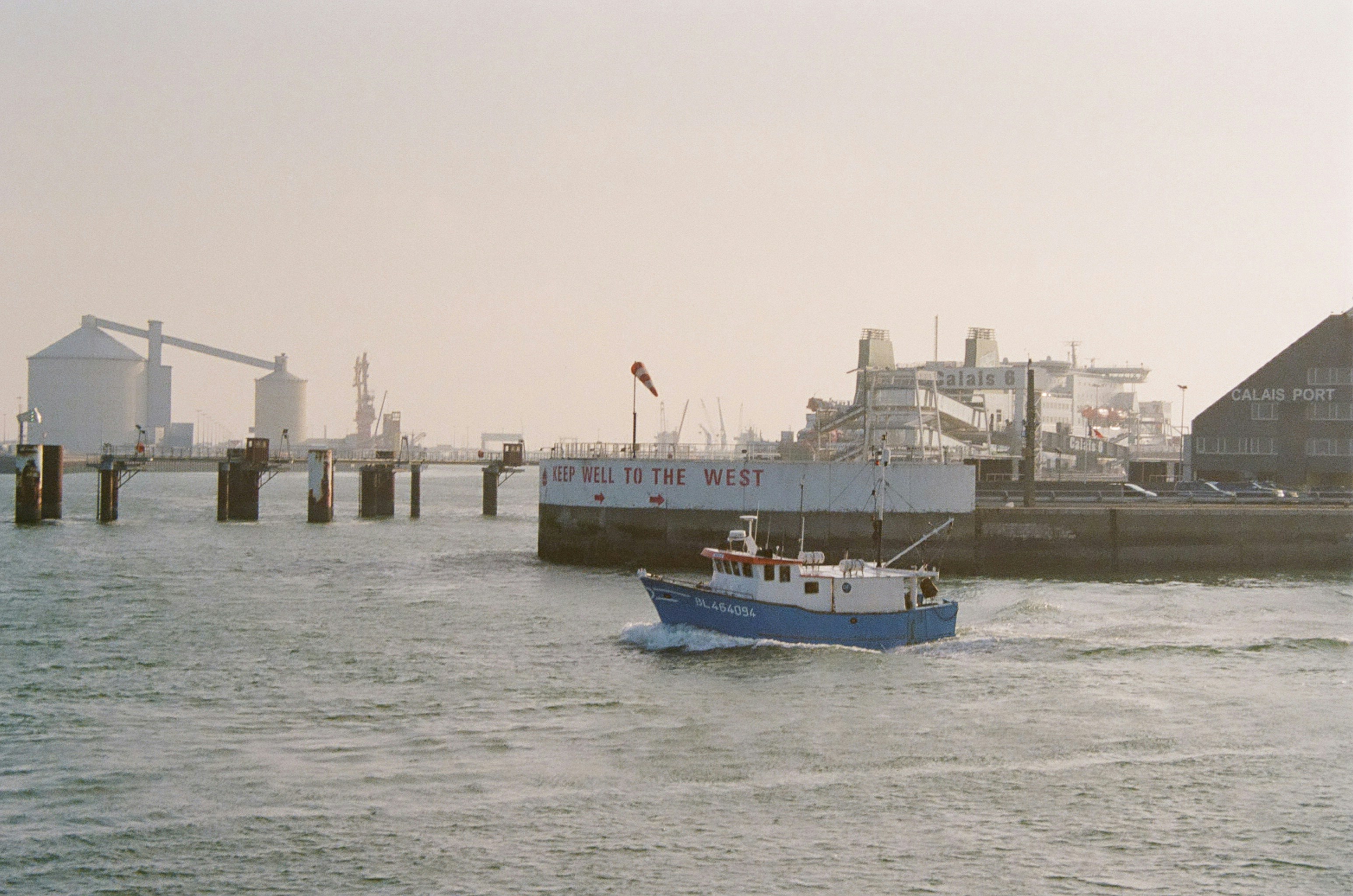 a blue and white boat in a body of water, 