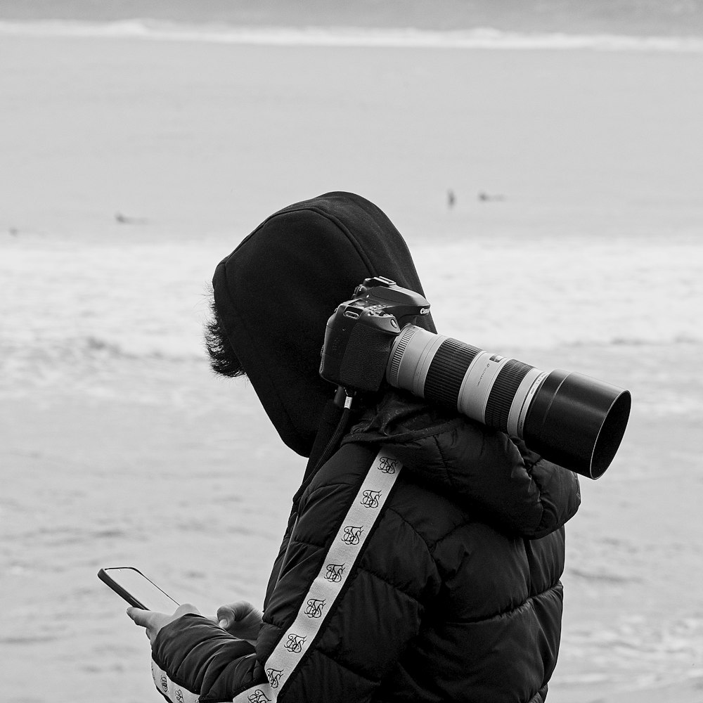 a person with a camera and a cell phone