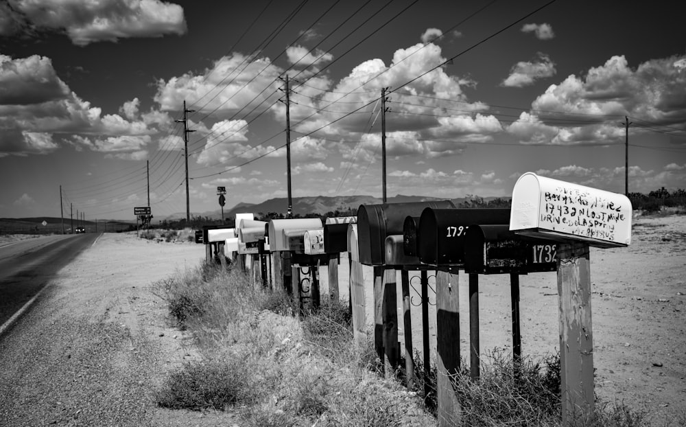a row of mail boxes sitting on the side of a road