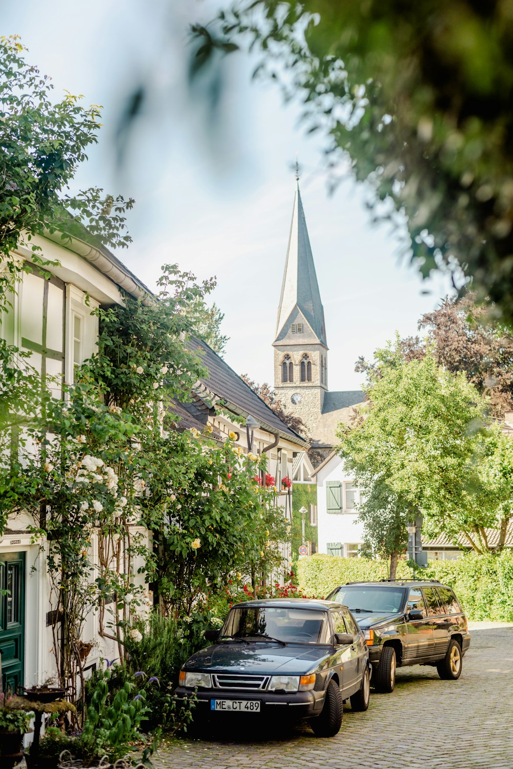 a couple of cars parked in front of a church