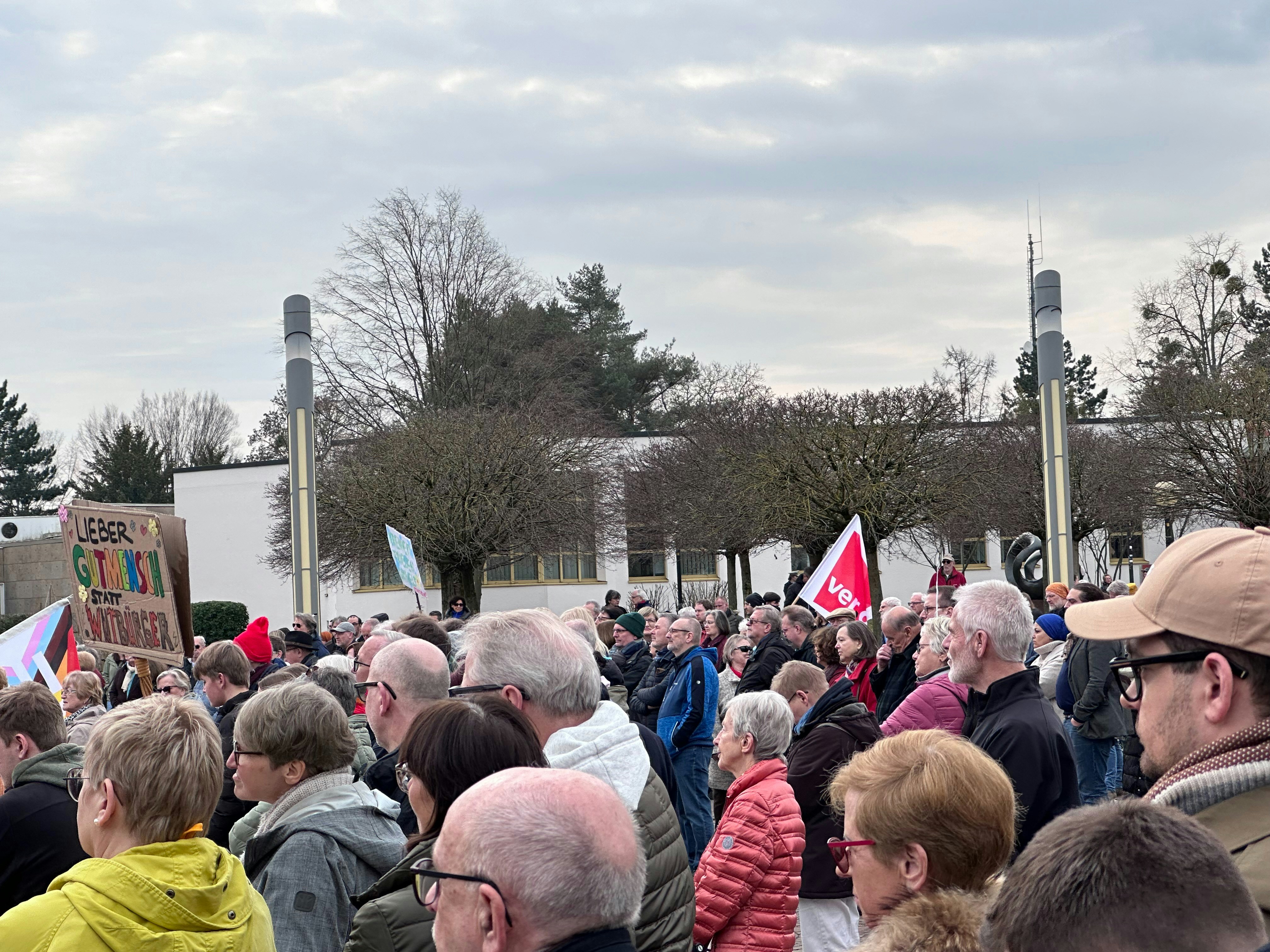 a large group of people standing around each other