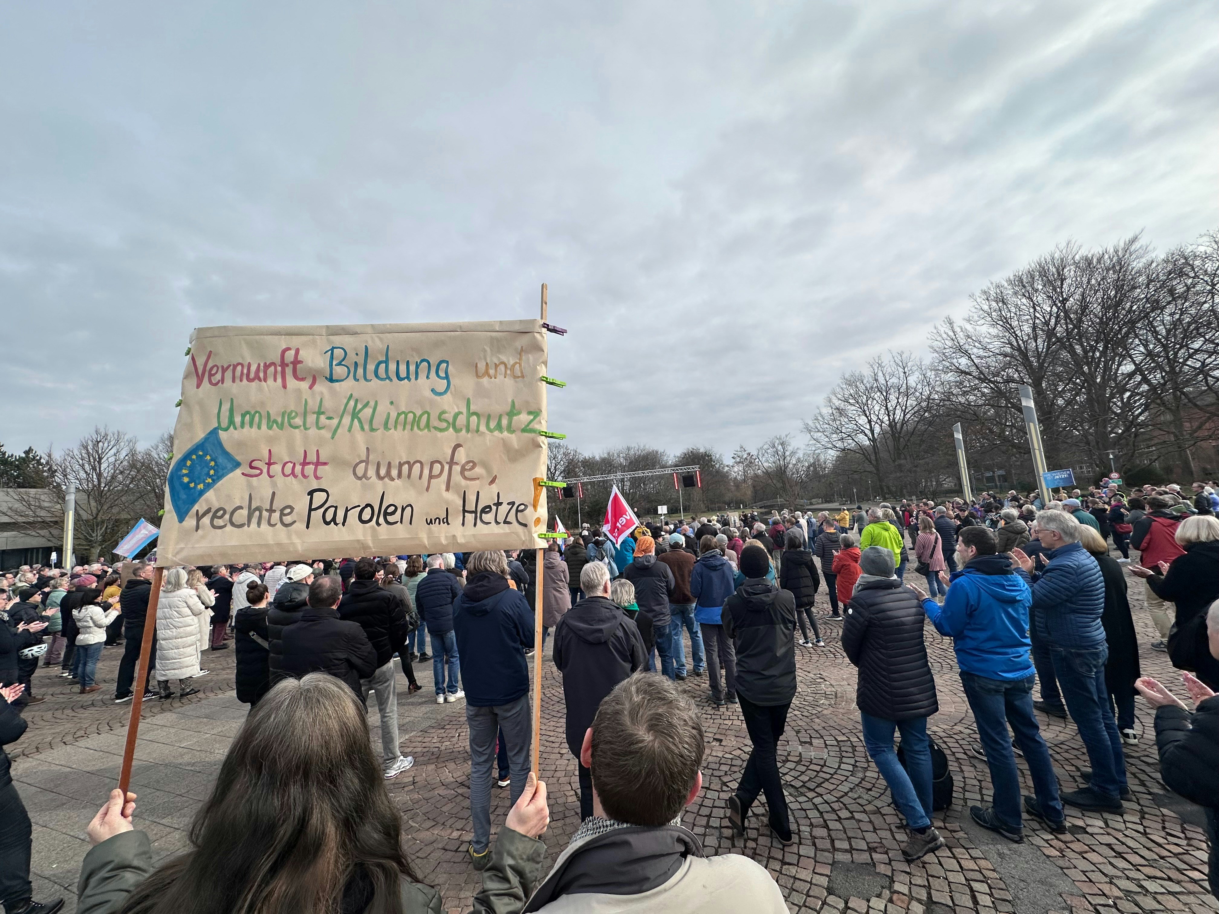 a group of people holding a sign in a protest