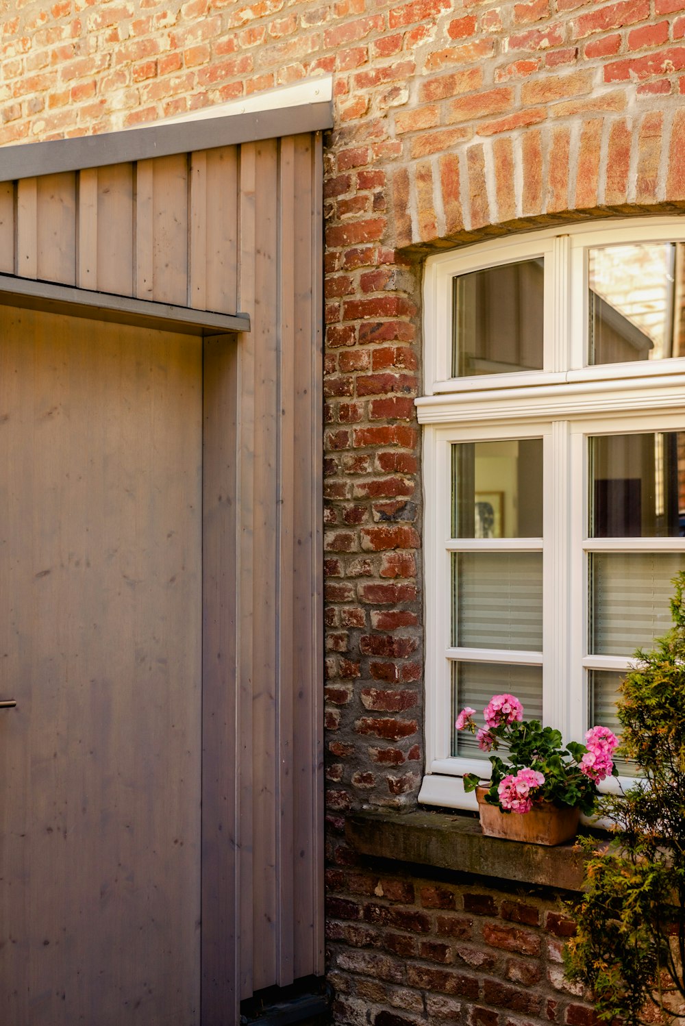 a brick building with a wooden door and window