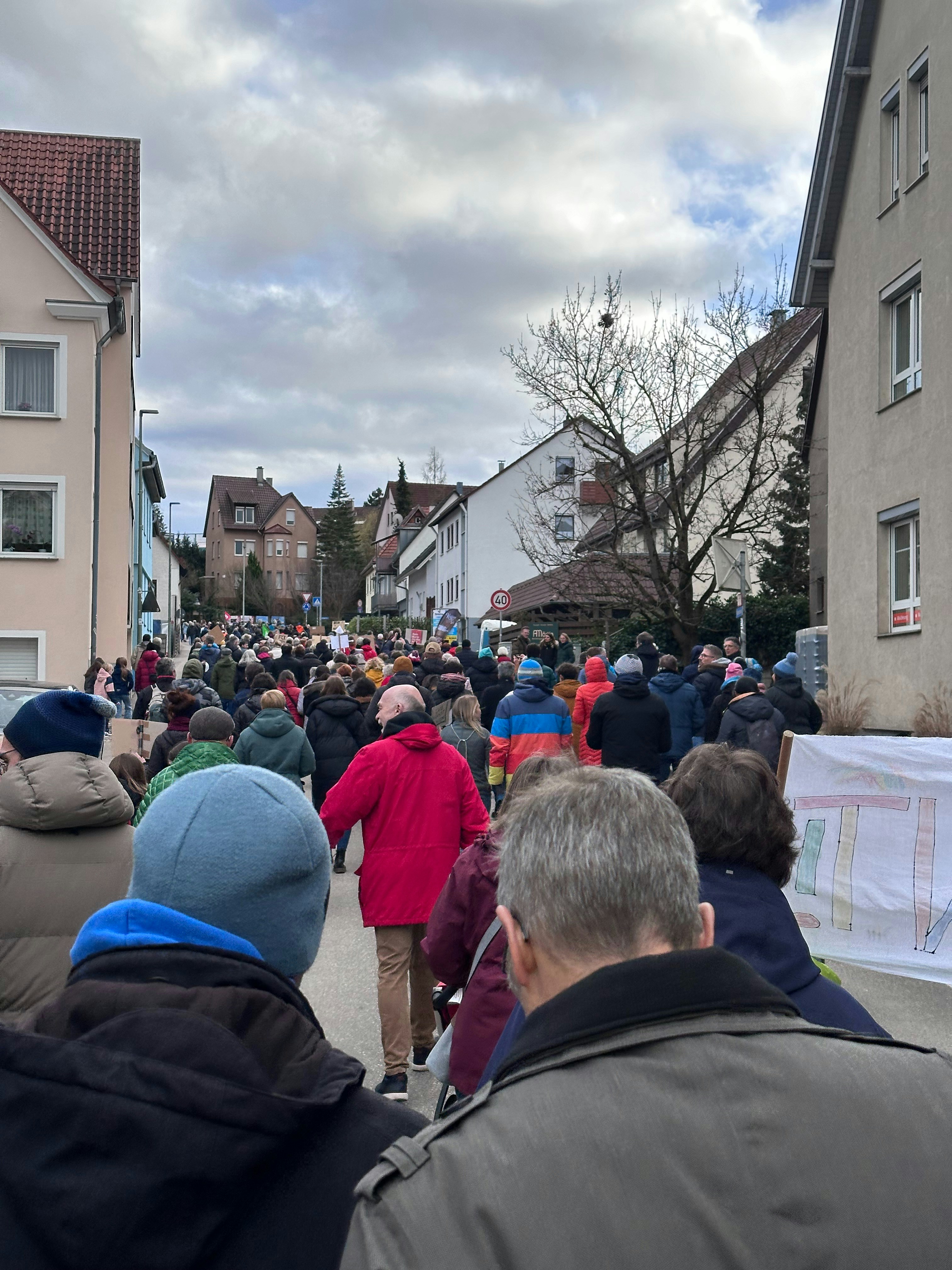 a crowd of people walking down a street